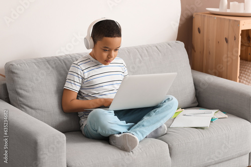 Young boy wearing headphone...