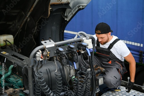 Mechanic repairing the truck in service.
