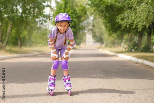 Funny laughing liberated girl rides roller skates. Protective sports accessories for extreme sports
