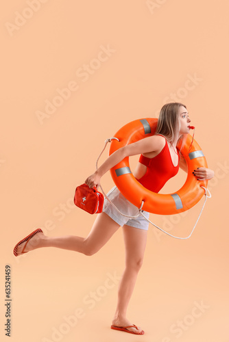 Female lifeguard with ring ...