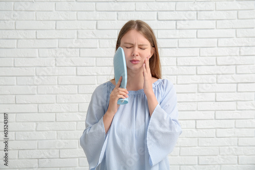 Young woman with tooth ache...