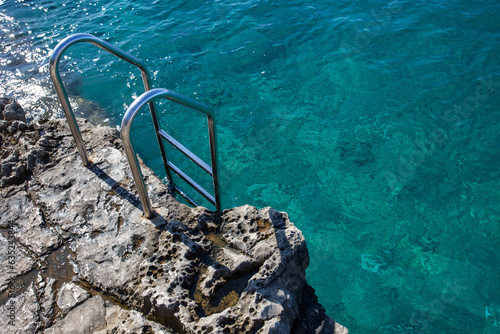 Принти на полотні Metal ladder for sea entrance on rock