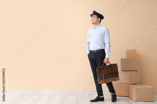 Young postman with bag and ...