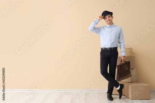 Young postman with bag and ...