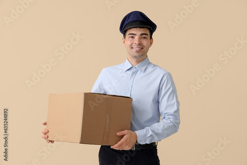 Young postman with parcel o...