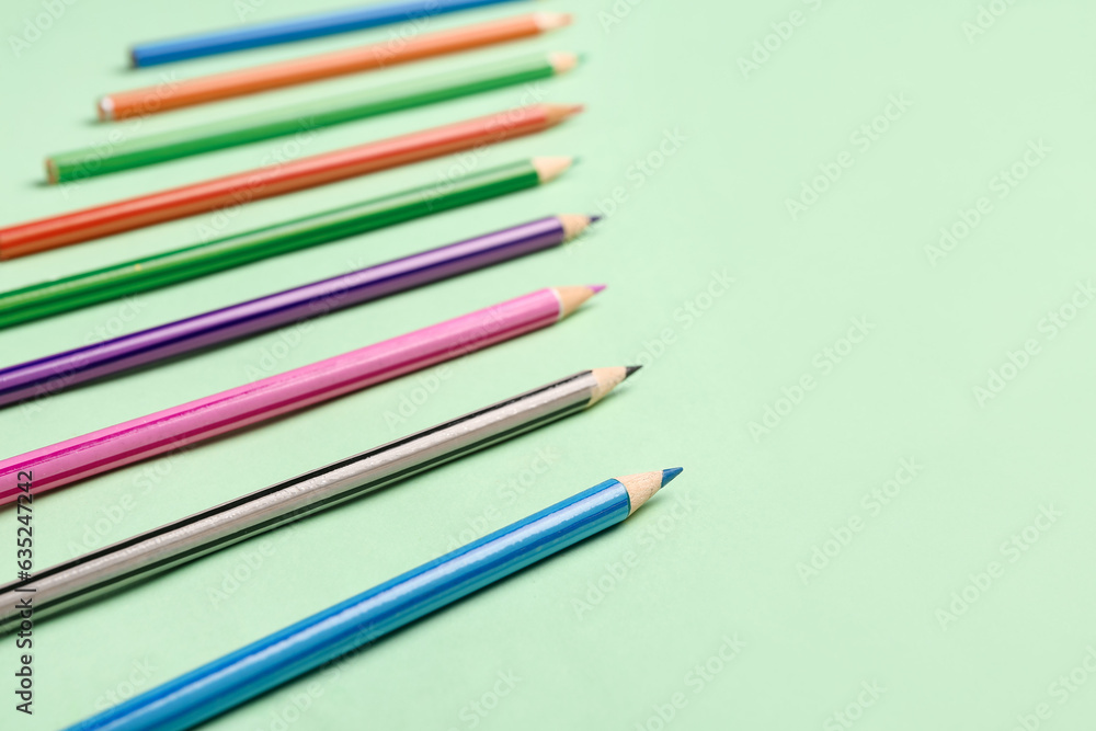 Obraz premium Group of colorful pencils on light green background
