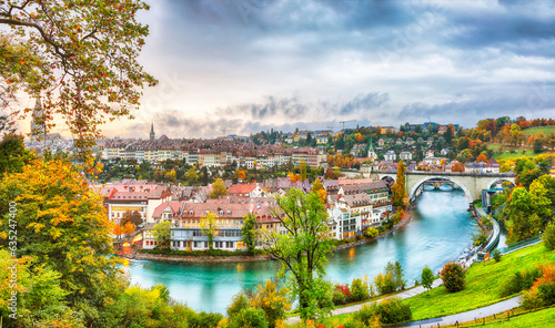 Amazing autumn view of Bern city on Aare river during evening with Pont de Nydegg bridge and Nydeggkirche - Protestant church
