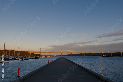 Outdoor exterior view at Vejle Havn Mole and background of Vejle Fjord Bridge during twilight sky in Vejle  Denmark. 
