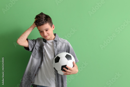 Upset little boy with socce...