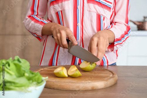 Woman in striped shirt slic...