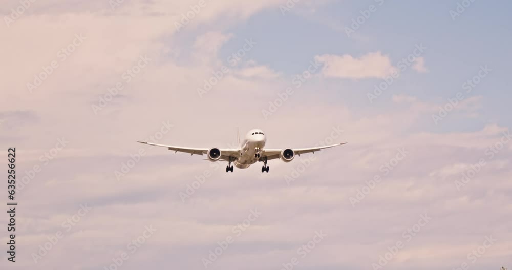 A commercial jet flying through a beautiful cloudy sky A commercial jet flying through a beautiful cloudy sky
