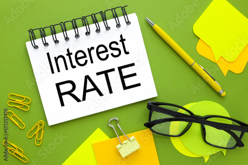 interest rates green background. sticker and glasses. business concept photo