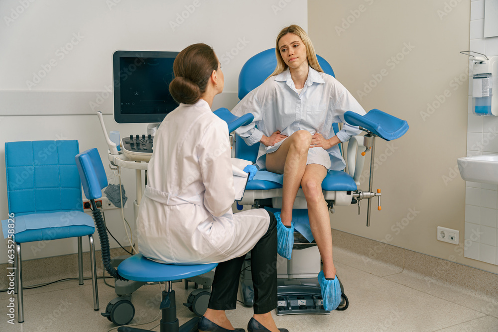 Woman on appointment with her gynecologist during visit to women's consultation. High quality photo - obrazy, fototapety, plakaty 