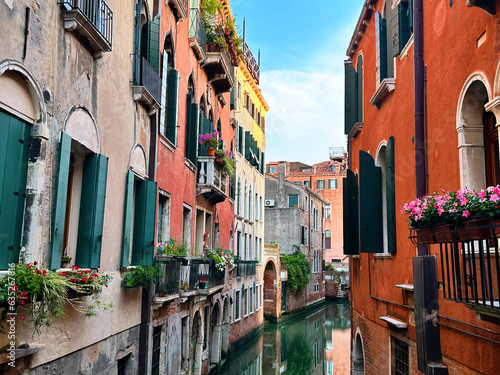 Venice View: Colorful houses, canals and waterways in Italy's timeless city where gondolas glide beneath arched bridges in a historic city that floats on romance