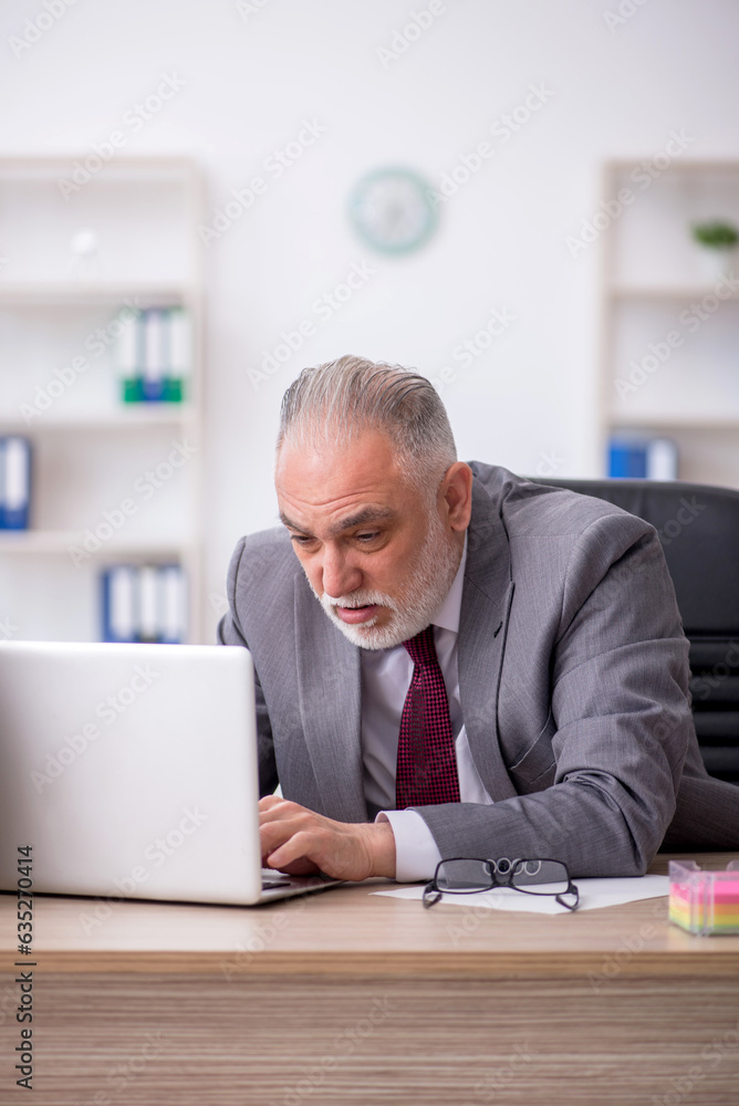 Old male employee and too much work in the office Old male employee and too much work in the office