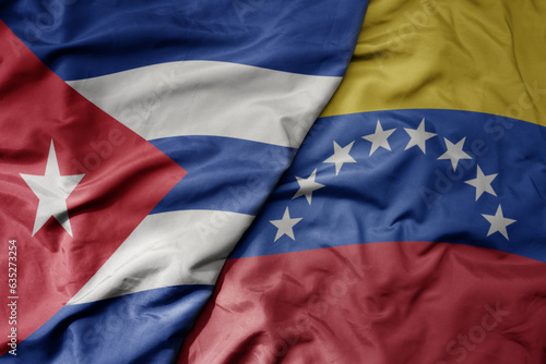 Photography big waving realistic national colorful flag of cuba and national flag of venezuela