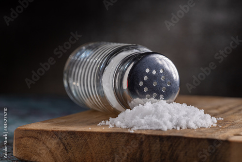 Glass salt shaker on the table. photo