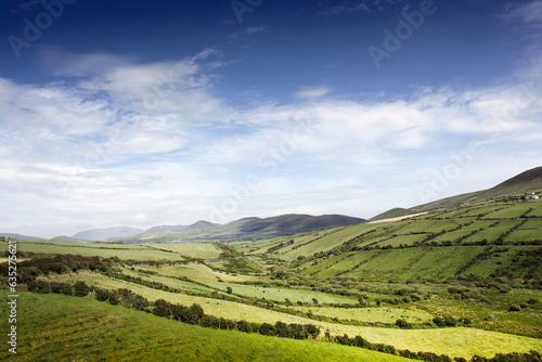 Rolling green hills with blue sky in Ireland