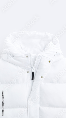 Closeup of white ripstop gilet with hood, isolated on vertical copy-space background.
