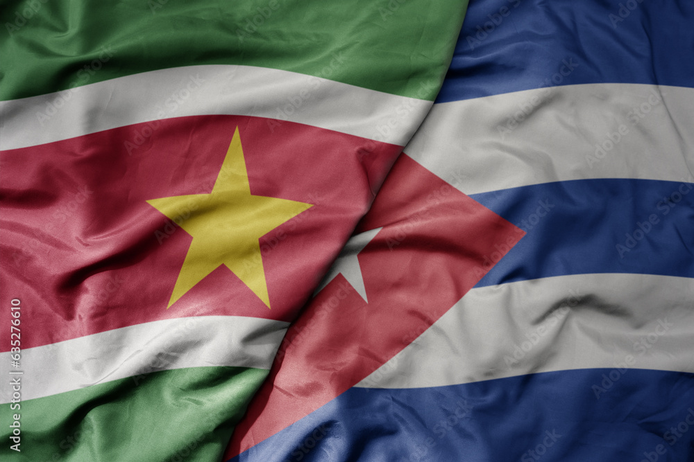 Fototapeta premium big waving realistic national colorful flag of suriname and national flag of cuba .