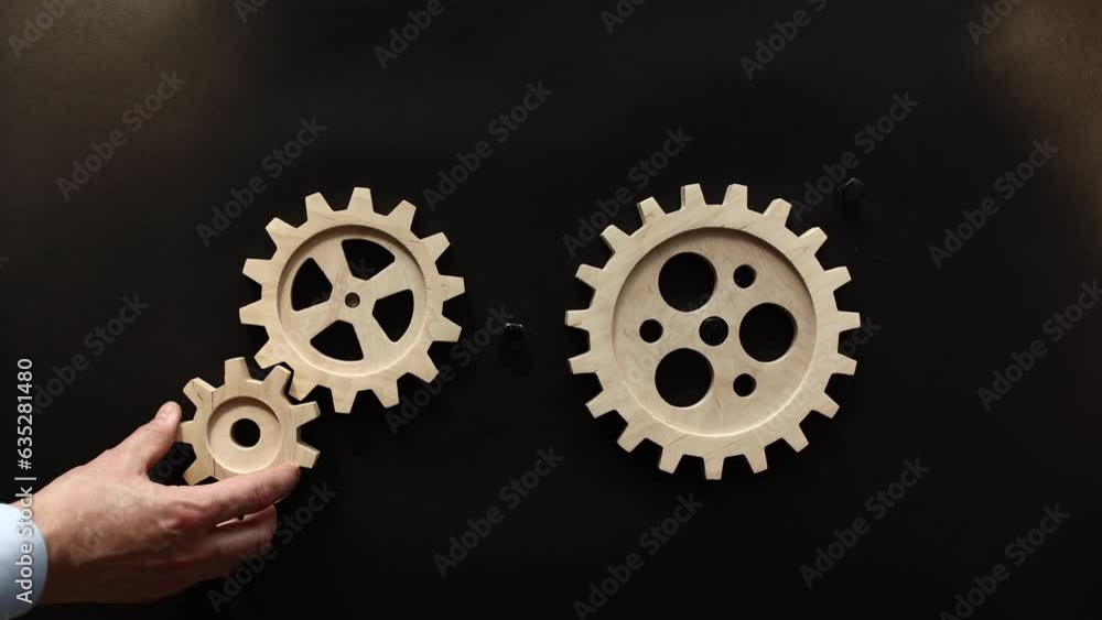 Businessmen are stacking gold and silver gears Businessmen are stacking gold and silver gears