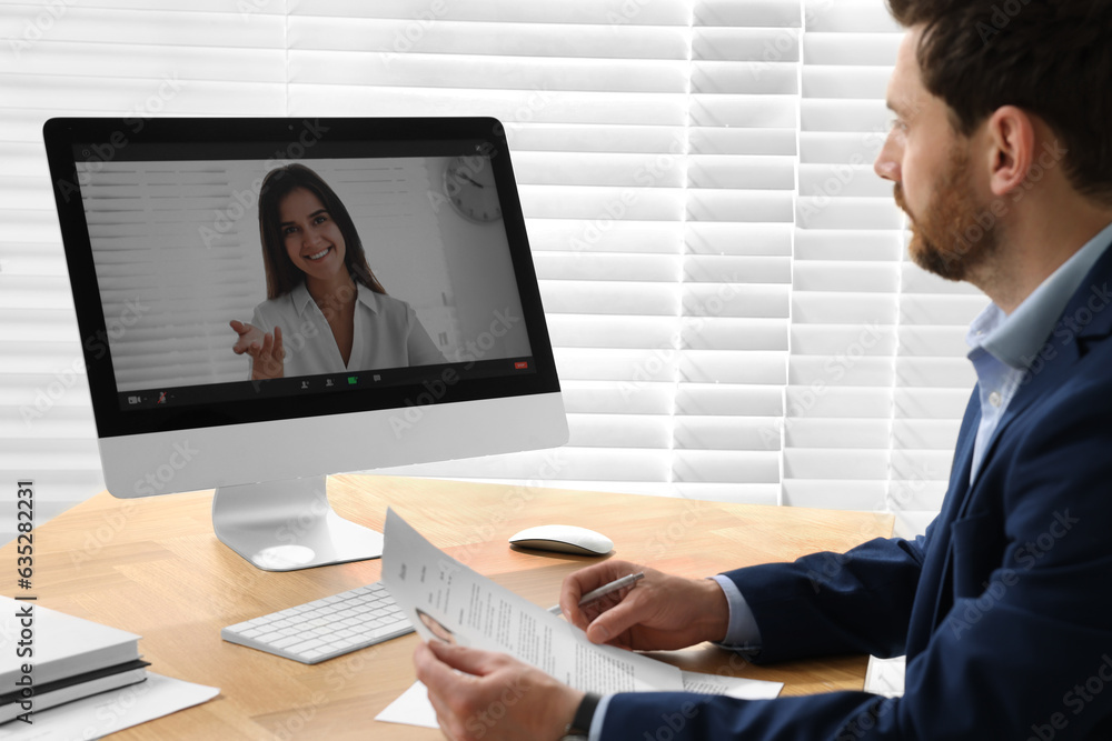 Human resources manager conducting online job interview via video chat on computer Human resources manager conducting online job interview via video chat on computer