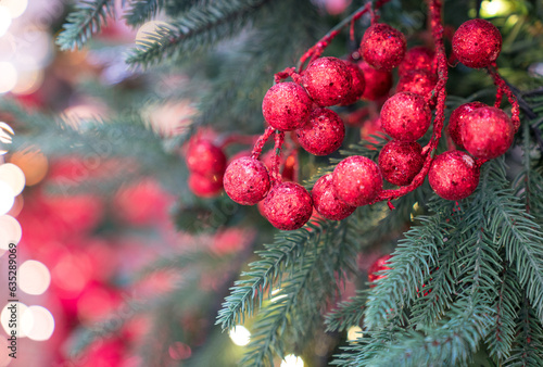Christmas red ornaments hang on tree  with bokeh background.