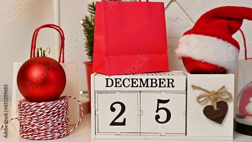 Still life christmas concept.Wooden calendar with december 25 date and ornaments around