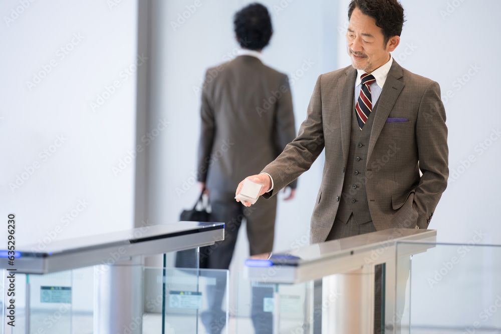 Businessman entering by touch at the entrance of a gate at a company, airport, etc. Businessman entering by touch at the entrance of a gate at a company, airport, etc.