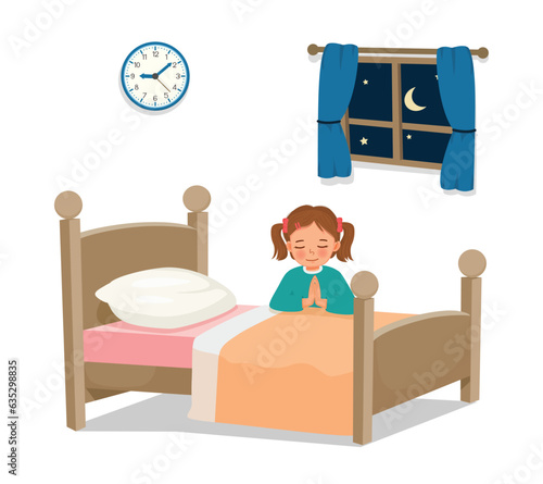 little girl praying before going to bed in the bedroom