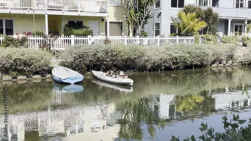 canal with boat and kayak docketing photo