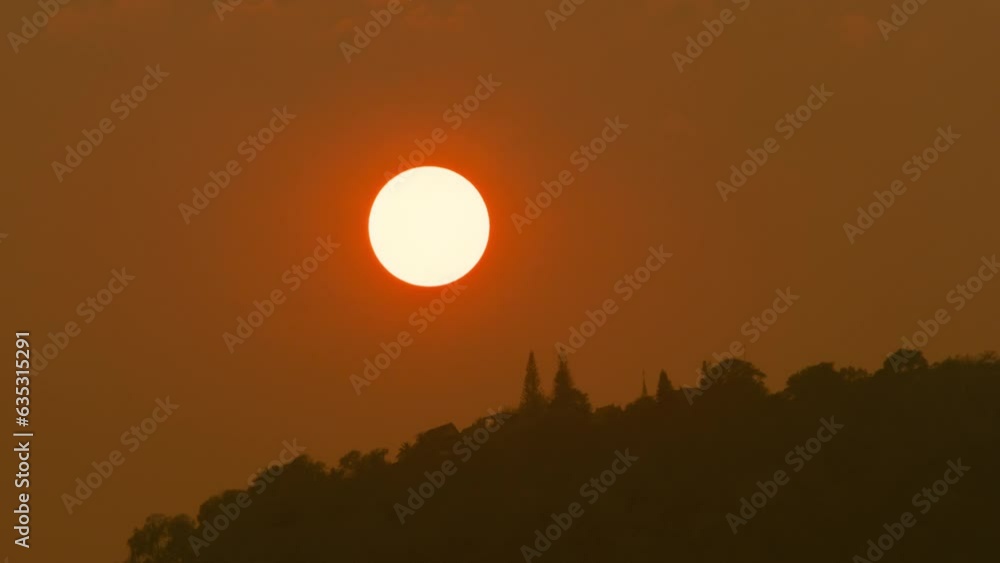 Time lapse of the sun setting over hills that are covered with clouds, in the style of smokey background. Time lapse of the sun setting over hills that are covered with clouds, in the style of smokey background.