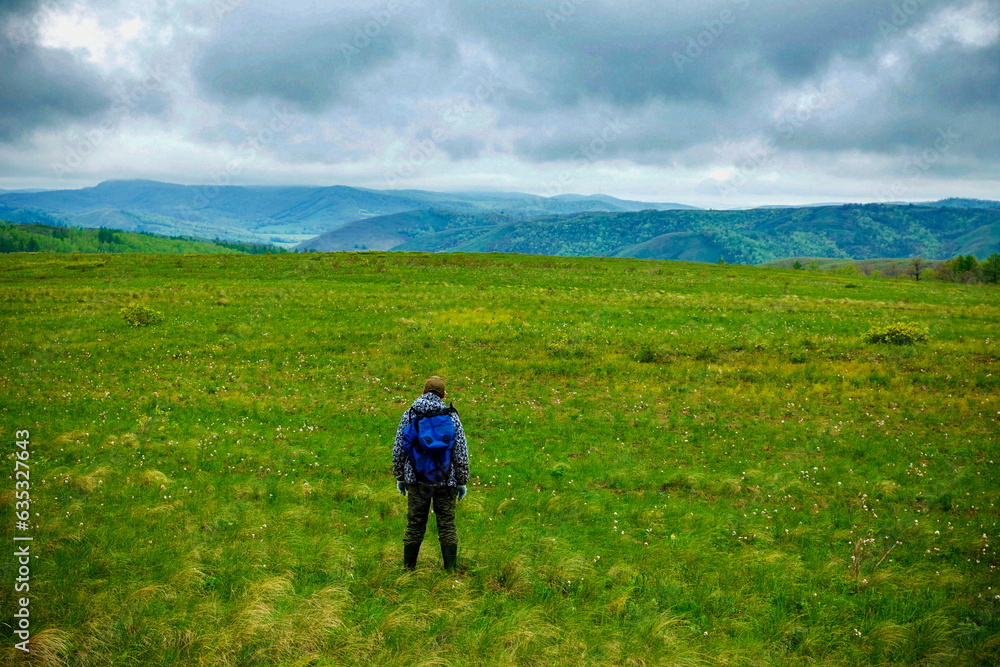 mature tourist travels in the ural mountains in early spring