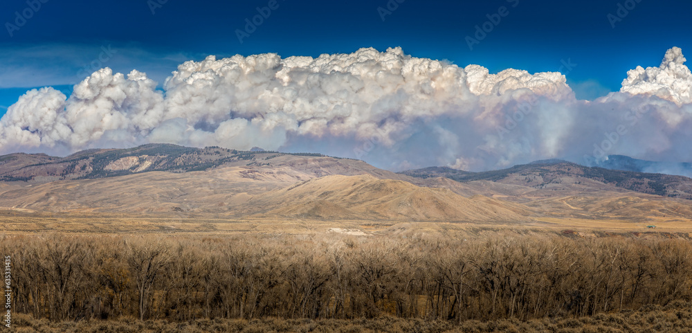 Panoramic view of thick smoke clouds over mountains in Colorado due to a wildfire