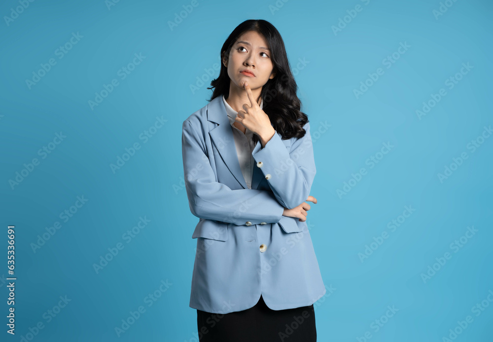 image of young businesswoman posing on blue background image of young businesswoman posing on blue background
