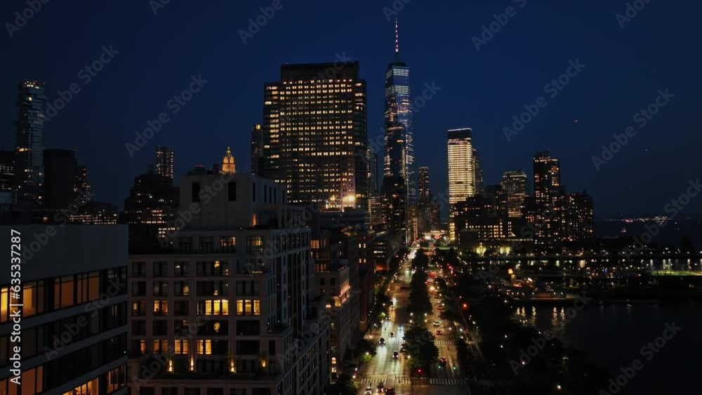 A view of a city at night from the top of a building A view of a city at night from the top of a building