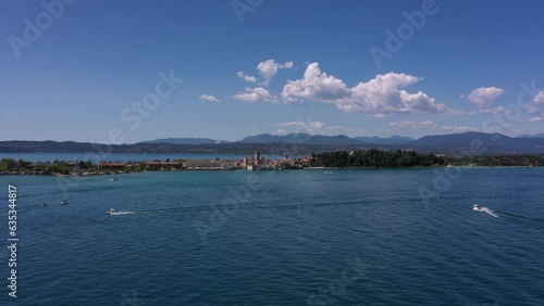 Sirmione on Lake Garda in Italy, slow motion shot by drone. Scaliger Castle of the city of Sirmione 4K video on drone. Sirmione drone view.
Moving forward to the peninsula of sirmione. photo