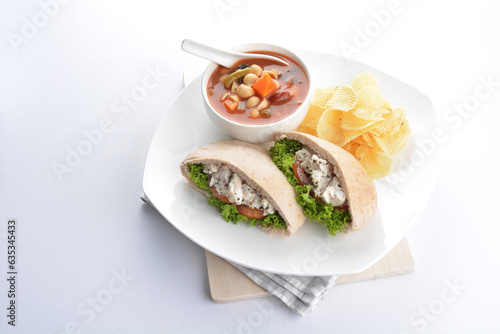 chicken tuna salad kebab open pocket bread with tomato abc soup and crispy potato chips combo healthy set in plate on white background asian halal food cuisine vegan menu for cafe design