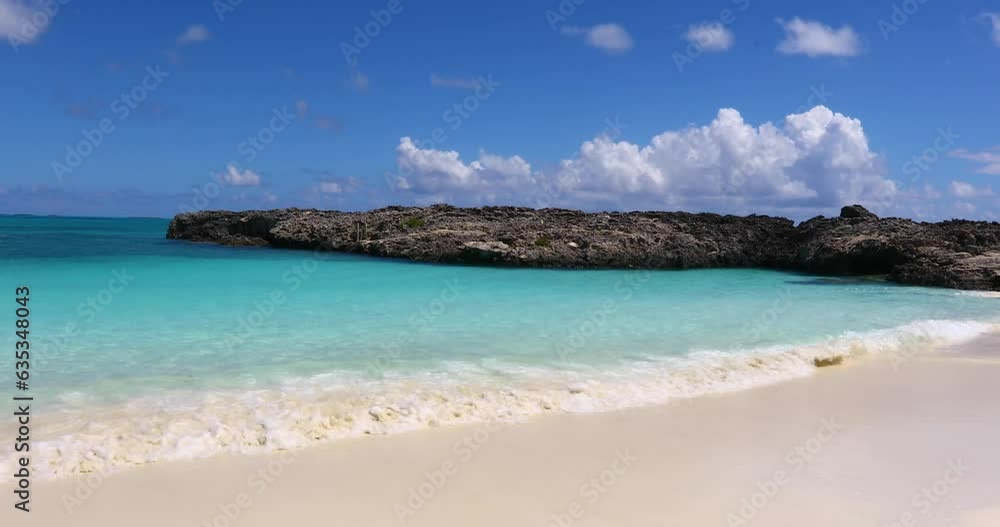 Static video of forbes Hill Beach on Exuma in the Bahamas. Rock formation sticks out on the right side. Static video of forbes Hill Beach on Exuma in the Bahamas. Rock formation sticks out on the right side.