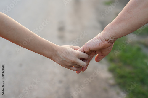 parent holds the hand of a small child © maeching