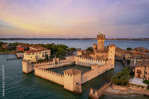 The beautiful coastline of Sirmione in Italy on Lake Garda at sunrise. The historic Scaliger Castle.