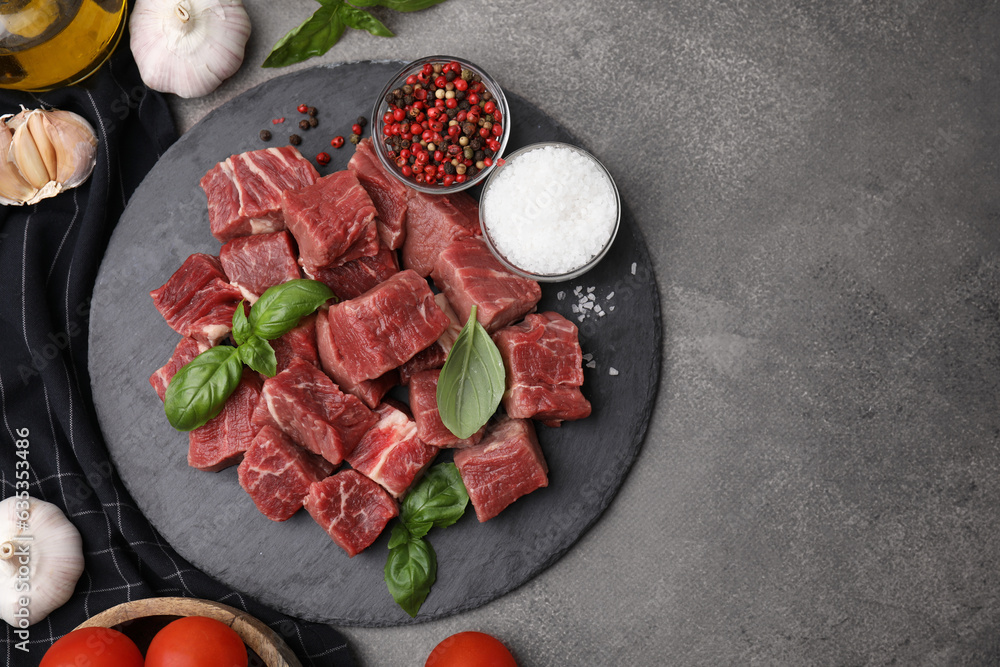 Flat lay composition with cut fresh beef meat on brown table. Space for text Flat lay composition with cut fresh beef meat on brown table. Space for text