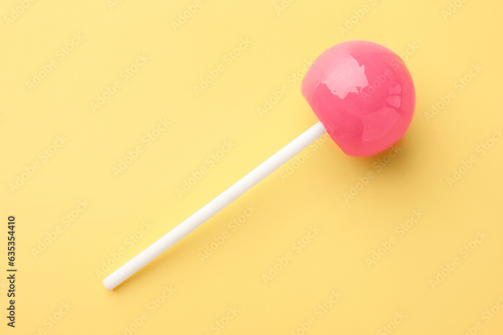 Tasty lollipop on yellow background, top view Tasty lollipop on yellow background, top view