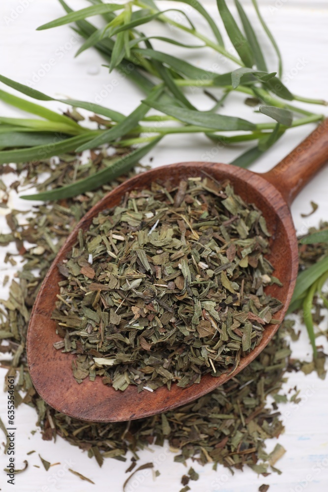 Spoon of dry tarragon and fresh leaves on white wooden table, above view Spoon of dry tarragon and fresh leaves on white wooden table, above view