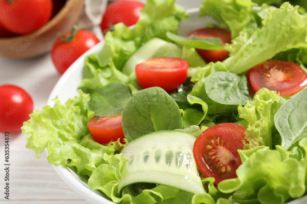 Delicious vegetable salad on white table, closeup Delicious vegetable salad on white table, closeup