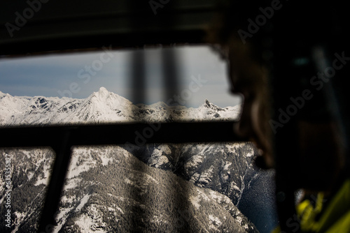 Profile view of passenger and scenic view out helicopter window photo