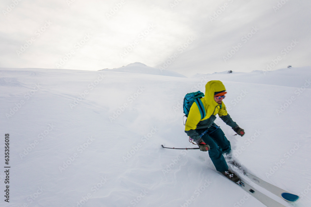 Skier enjoying fresh tracks on a remote mountain in Canada Skier enjoying fresh tracks on a remote mountain in Canada