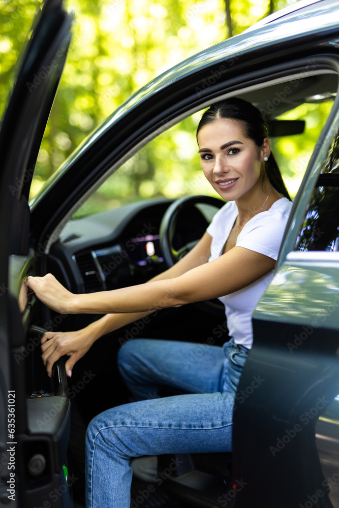 Young woman getting out of car. Outdoors Young woman getting out of car. Outdoors