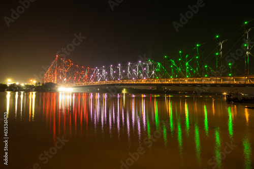Howrah bridge - The historic cantilever bridge on the river Hooghly lit with tricolor of India on the occasion of Independence day of India. Howrah bridge is considered as the busiest bridge in India.