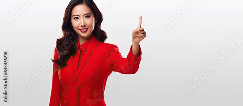 Beautiful Asian woman wearing red outfit presenting something isolated on white background